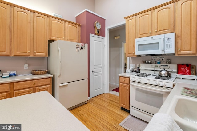 103 Dylan Cir, Avondale, PA 19311 - kitchen featuring white appliances, light countertops, light wood-type flooring, and light brown cabinetry