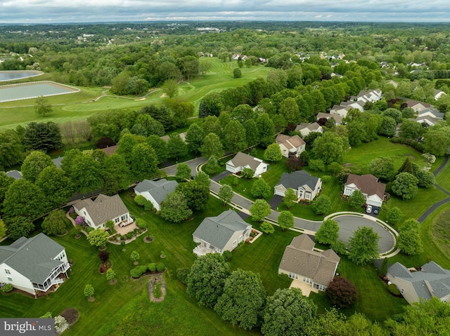 aerial view of residential area featuring a large body of water