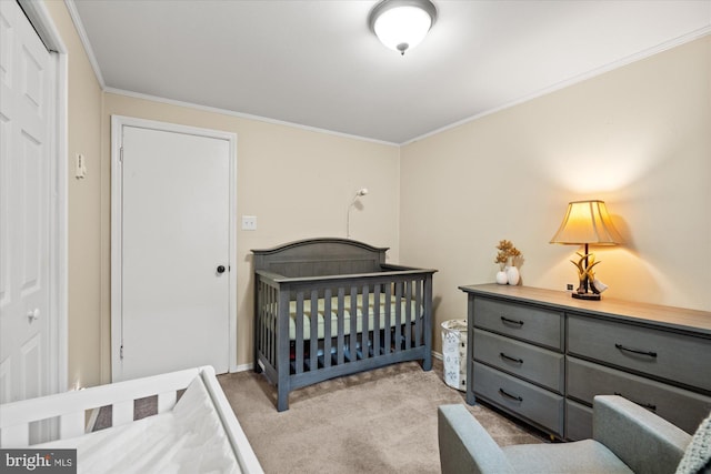 bedroom featuring light carpet, ornamental molding, baseboards, and a nursery area