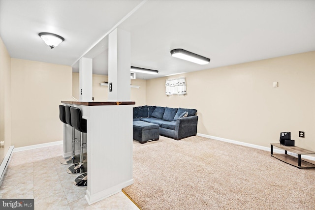 living area with baseboards and light tile patterned flooring