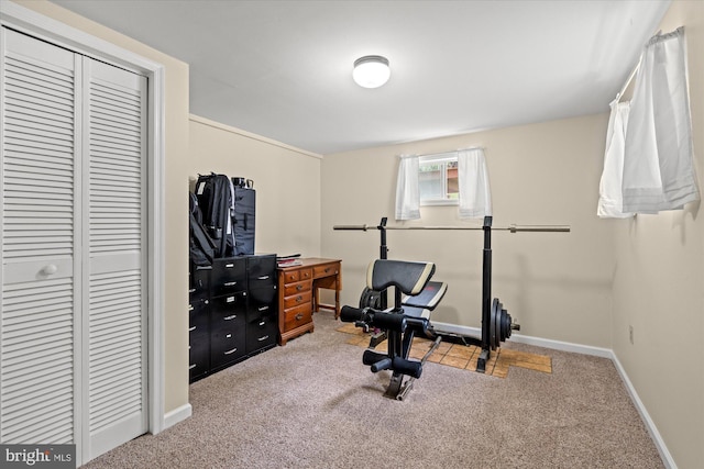 workout area featuring carpet floors and baseboards