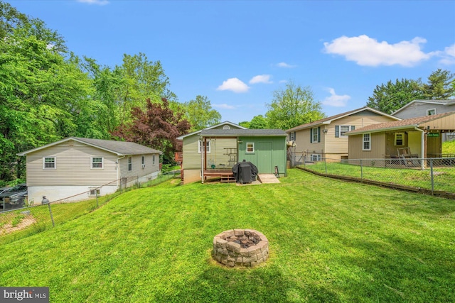 rear view of house featuring an outdoor fire pit and an outdoor structure