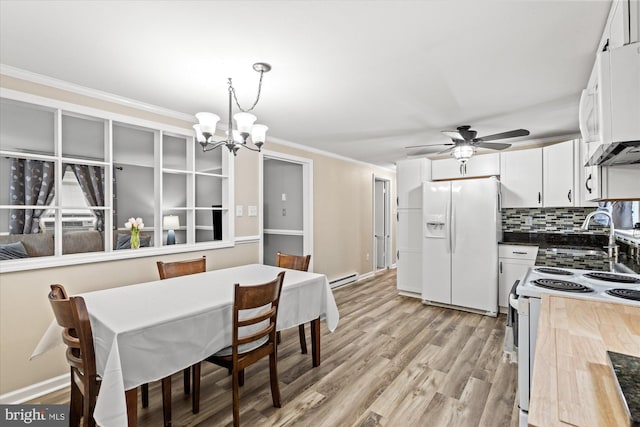 dining area with a baseboard radiator, a chandelier, ceiling fan, light wood finished floors, and crown molding