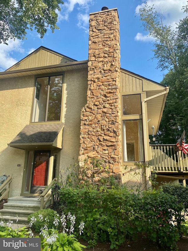411 Lynetree Dr Unit 12-C, West Chester, PA 19380 - view of home's exterior with stucco siding and a chimney