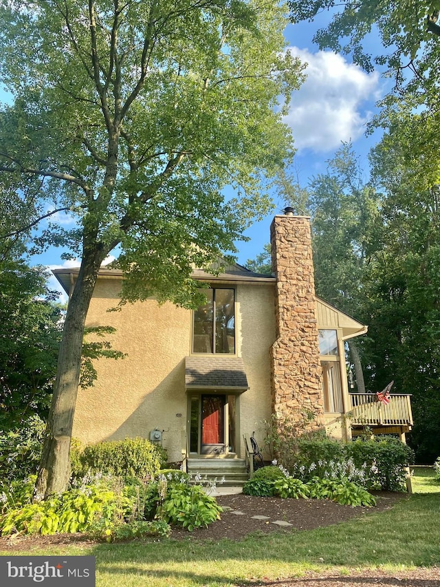 411 Lynetree Dr Unit 12-C, West Chester, PA 19380 - view of front facade with stucco siding and a chimney