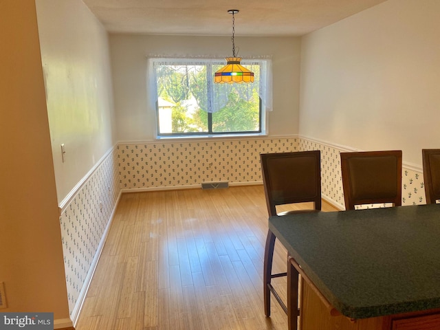 411 Lynetree Dr Unit 12-C, West Chester, PA 19380 - dining room with wallpapered walls, light wood finished floors, and a wainscoted wall