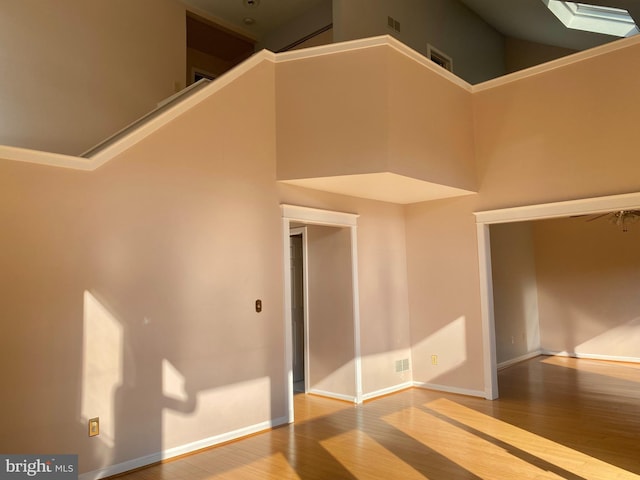 411 Lynetree Dr Unit 12-C, West Chester, PA 19380 - unfurnished room featuring wood finished floors, a high ceiling, baseboards, and a skylight
