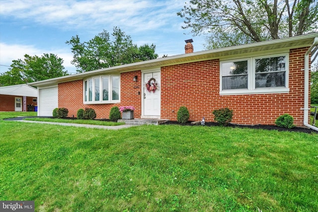 ranch-style home with a chimney, brick siding, a front lawn, and a garage