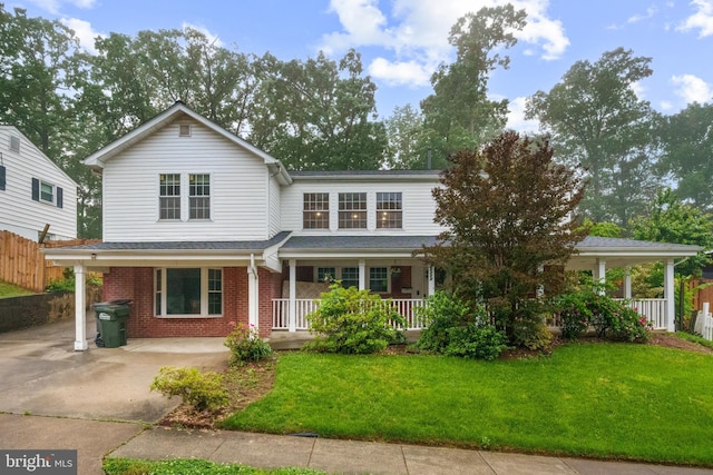 traditional-style home featuring a porch and brick siding