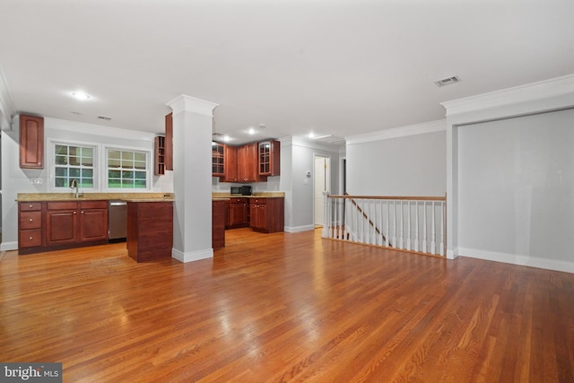 unfurnished living room with wood finished floors, ornamental molding, baseboards, recessed lighting, and a sink