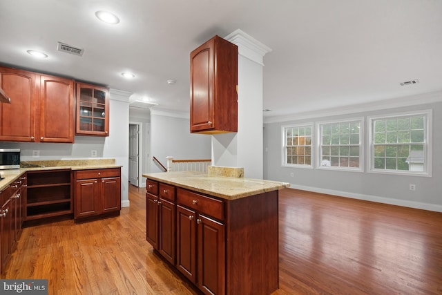 kitchen with ornamental molding, light wood-style flooring, baseboards, glass insert cabinets, and recessed lighting