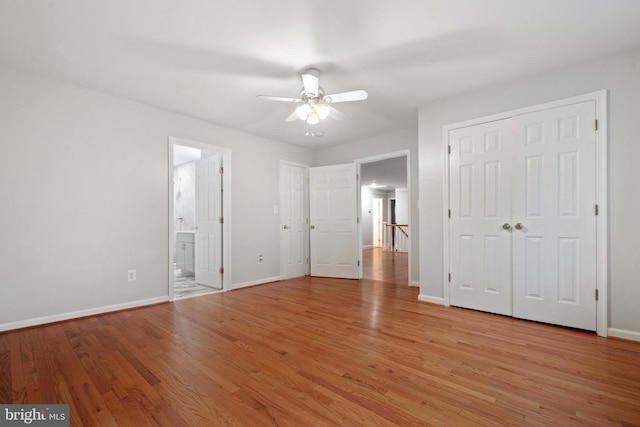 unfurnished bedroom with light wood-type flooring, baseboards, connected bathroom, and ceiling fan