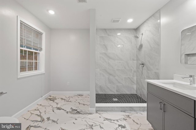 full bath featuring marble look tile flooring, baseboards, recessed lighting, vanity, and tiled shower