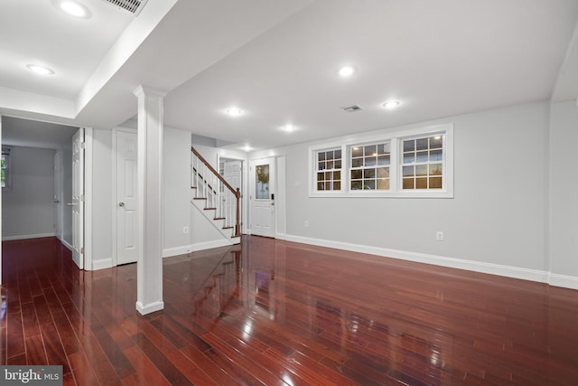 finished basement with stairs, baseboards, wood finished floors, and recessed lighting