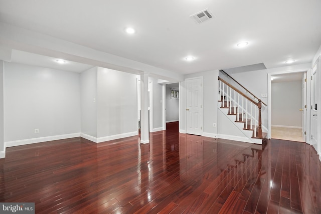finished basement with stairs, baseboards, wood finished floors, and recessed lighting