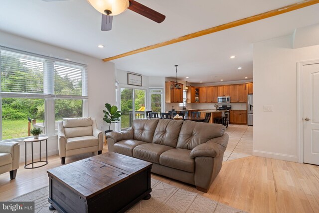 living area featuring a ceiling fan, light wood finished floors, recessed lighting, and baseboards