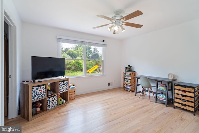 office area featuring wood finished floors, a ceiling fan, and baseboards