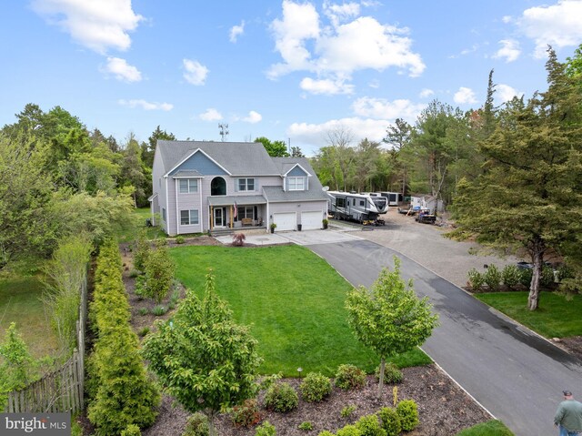 view of front facade with a front yard, a garage, and driveway