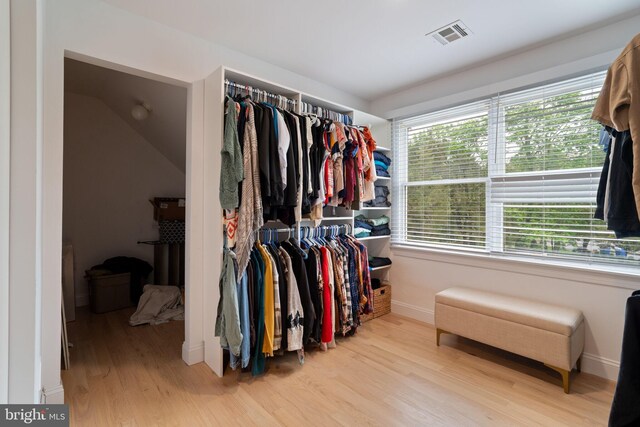 spacious closet with wood finished floors and lofted ceiling