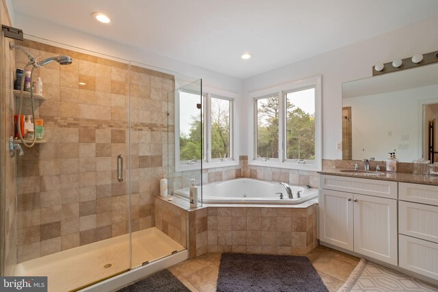 bathroom featuring a garden tub, a shower stall, vanity, tile patterned flooring, and recessed lighting