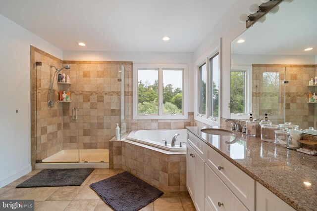 bathroom featuring healthy amount of natural light, a stall shower, recessed lighting, a bath, and tile patterned floors