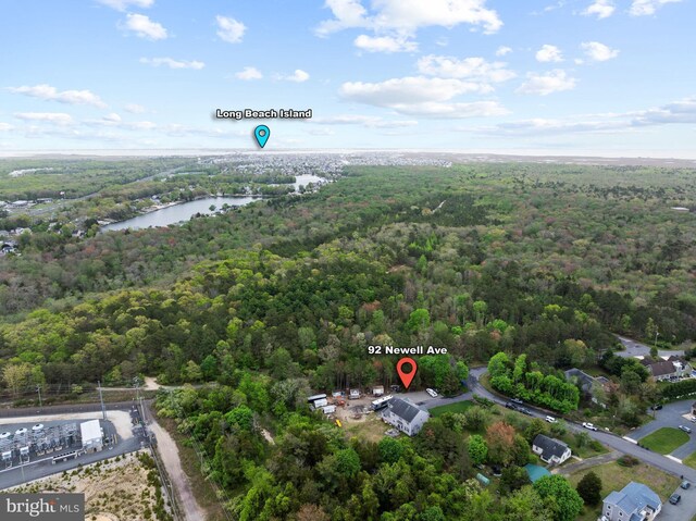 bird's eye view of a heavily wooded area and a large body of water