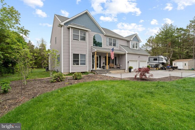 view of front of home with concrete driveway, a garage, a porch, and a front yard
