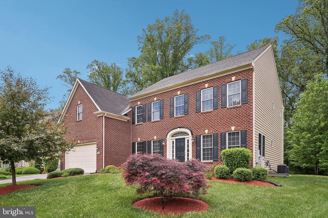 711 Bleak Hill Pl, Upper Marlboro, MD 20774 - view of front of home with central AC, a garage, a front yard, and brick siding