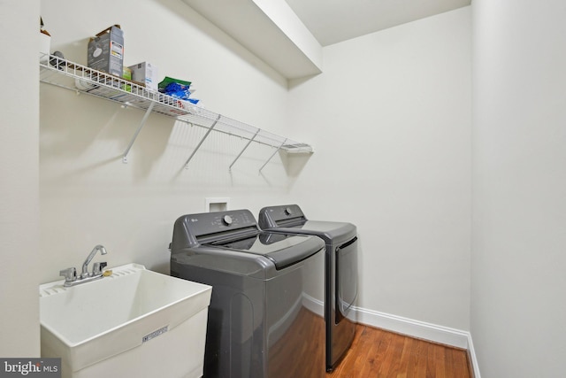 711 Bleak Hill Pl, Upper Marlboro, MD 20774 - laundry area featuring independent washer and dryer, wood finished floors, and baseboards