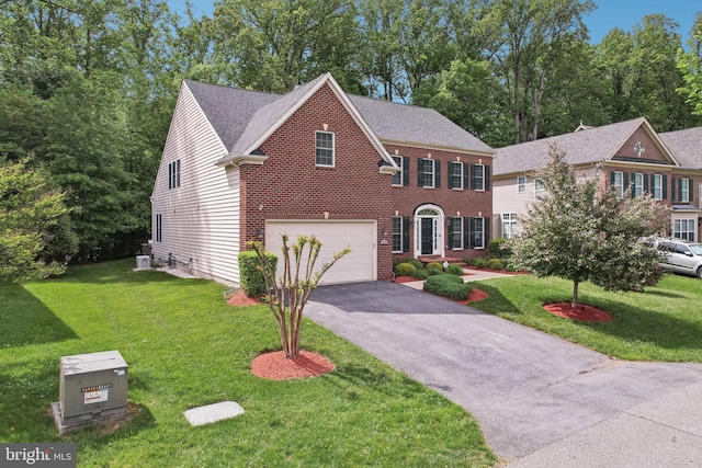 711 Bleak Hill Pl, Upper Marlboro, MD 20774 - view of front of home with an attached garage, driveway, a front yard, and brick siding