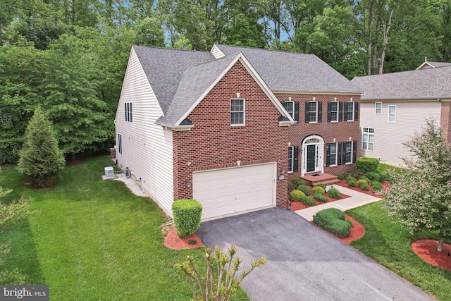 711 Bleak Hill Pl, Upper Marlboro, MD 20774 - view of front of home with asphalt driveway, a shingled roof, a front yard, and a garage