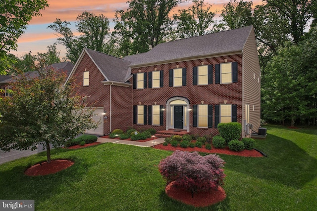 711 Bleak Hill Pl, Upper Marlboro, MD 20774 - view of front of home featuring central air condition unit, a front lawn, brick siding, and a shingled roof