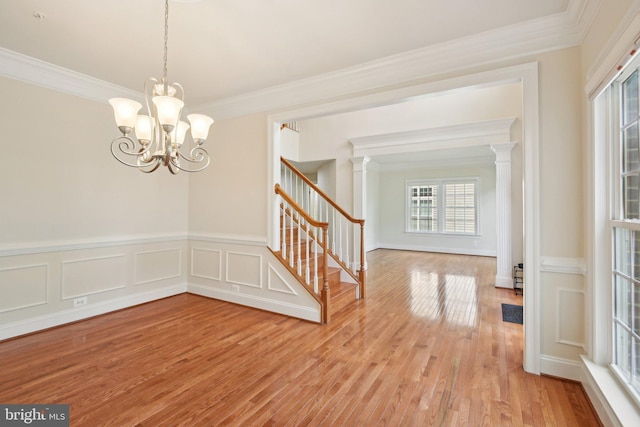 711 Bleak Hill Pl, Upper Marlboro, MD 20774 - spare room featuring stairs, crown molding, light wood finished floors, a chandelier, and decorative columns