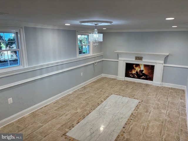basement featuring recessed lighting, a lit fireplace, baseboards, and a chandelier