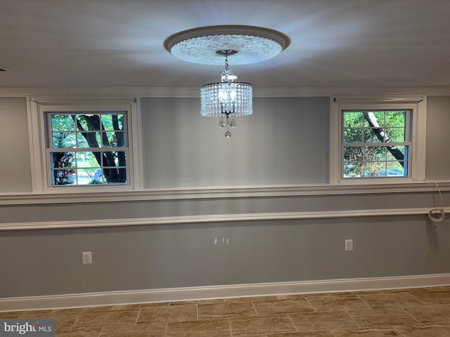 unfurnished dining area featuring a chandelier