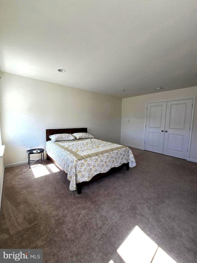 carpeted bedroom featuring baseboards