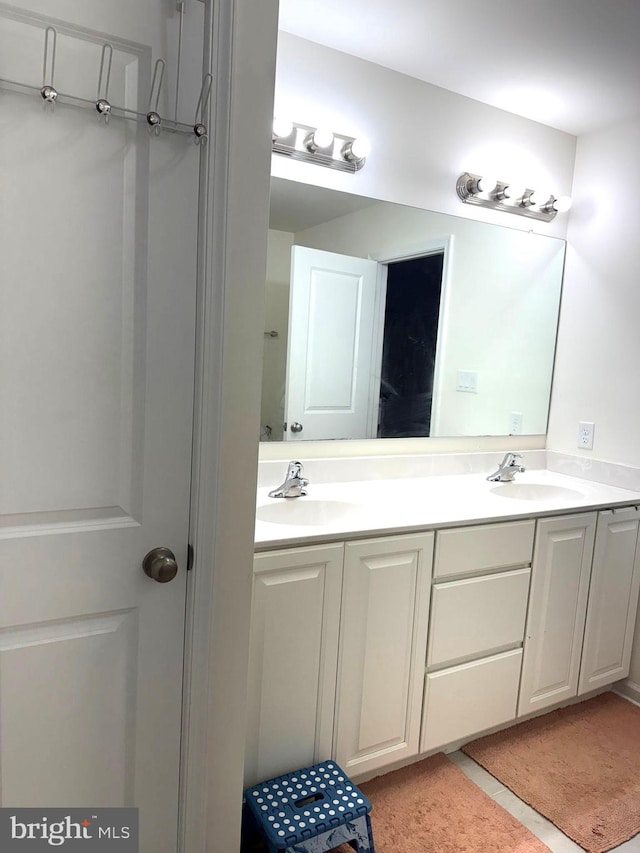 bathroom featuring double vanity and tile patterned floors