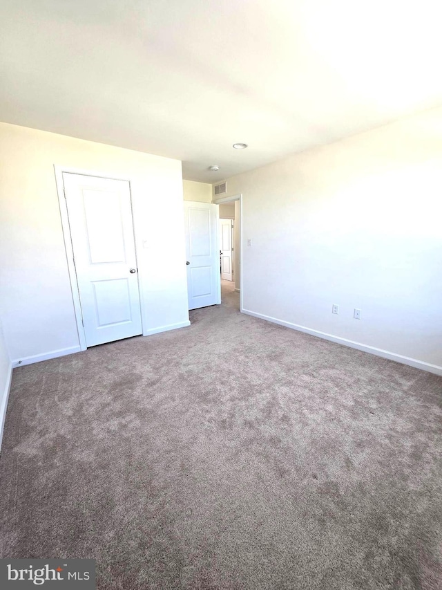 unfurnished bedroom with baseboards and carpet flooring