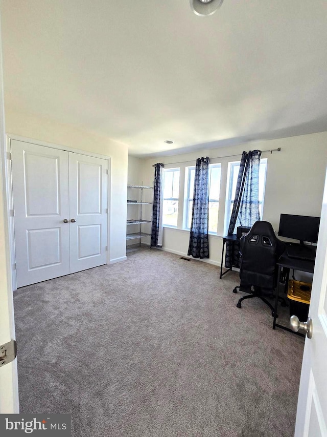 home office featuring carpet flooring and baseboards