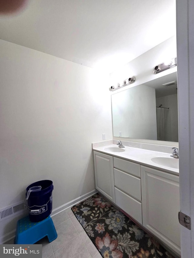full bath featuring double vanity and tile patterned floors