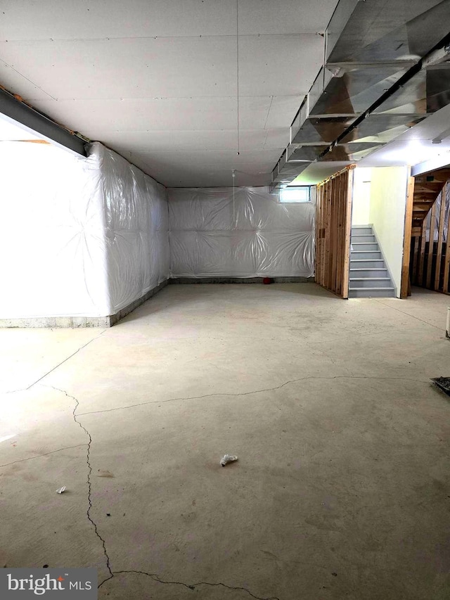 unfinished basement featuring stairs