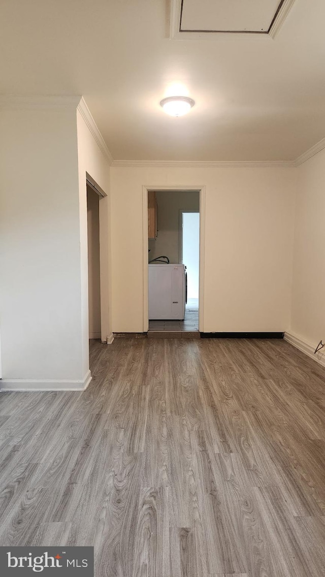 801 S Greenthorn Ave, Sterling, VA 20164 - spare room featuring ornamental molding, wood finished floors, attic access, baseboards, and washer / clothes dryer
