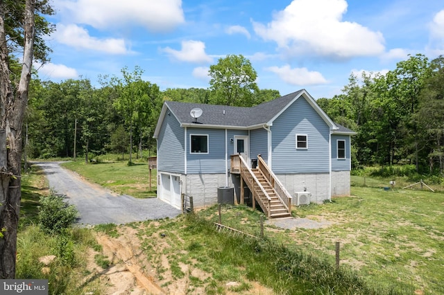 3612 Panhandle Rd, Front Royal, VA 22630 - rear view of property with driveway, an attached garage, central air condition unit, roof with shingles, and a lawn