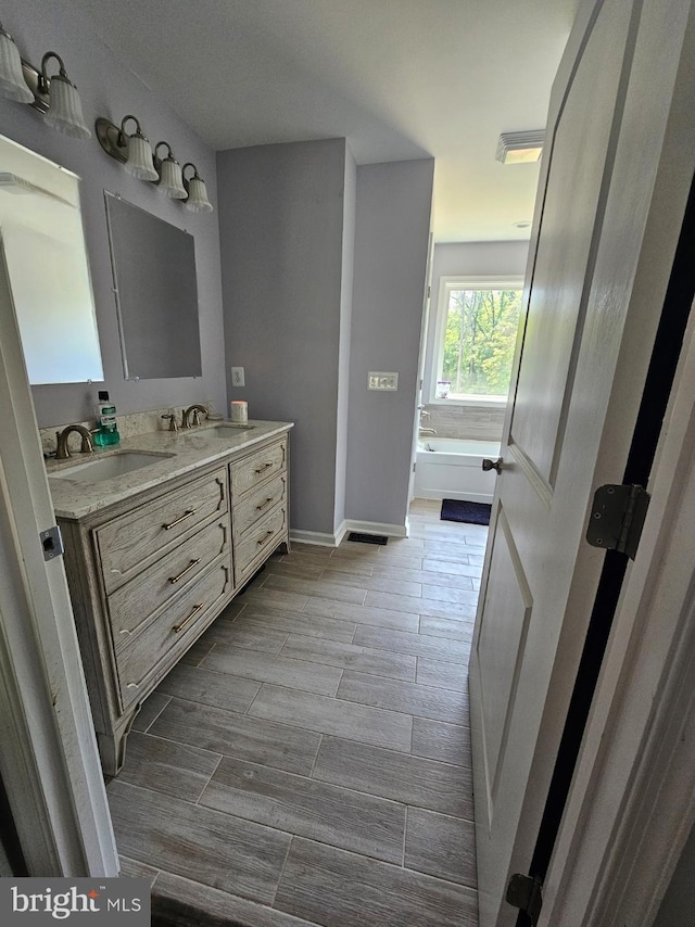 3612 Panhandle Rd, Front Royal, VA 22630 - full bath with double vanity, wood tiled floors, a garden tub, and baseboards