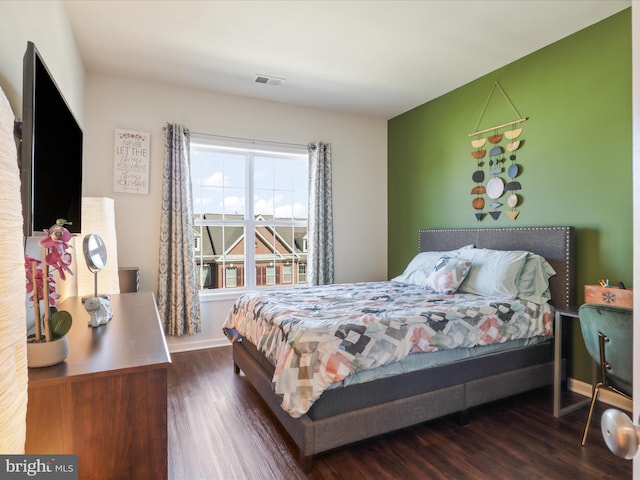 bedroom featuring wood finished floors and baseboards