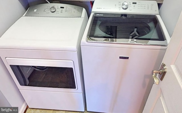 washroom with independent washer and dryer