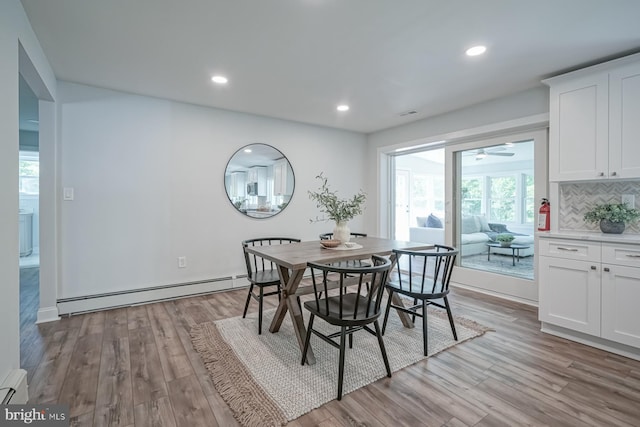 dining room with a baseboard radiator, light wood-style floors, recessed lighting, and ceiling fan