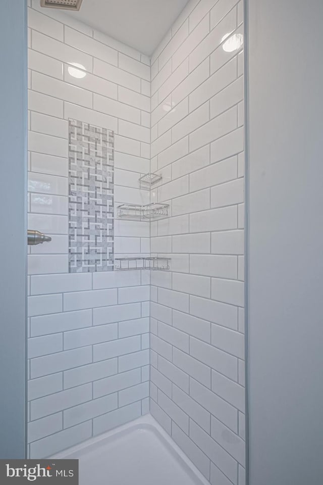 bathroom with a tile shower