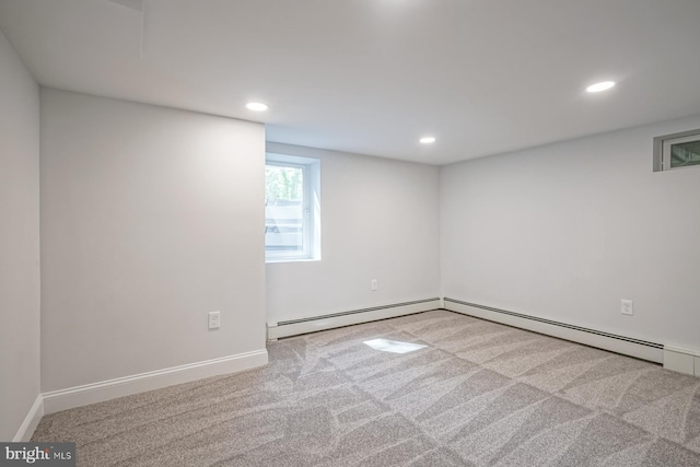 below grade area featuring carpet, recessed lighting, a baseboard heating unit, and baseboards