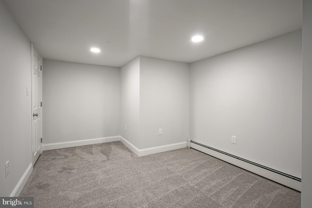finished below grade area featuring a baseboard heating unit, recessed lighting, carpet floors, and baseboards